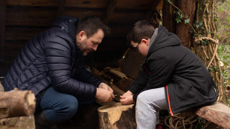Father & son learning bushcraft skills