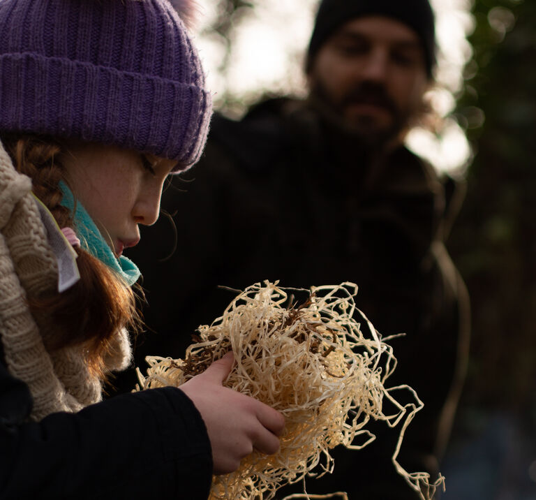 Young girl making a fire