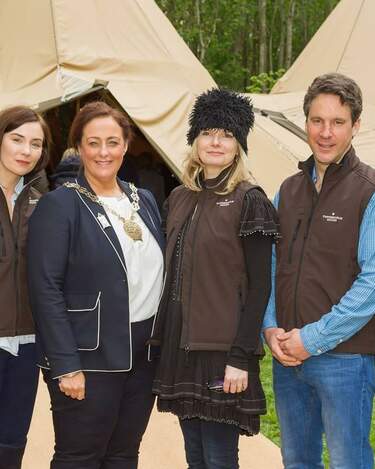 The team at Finnebrogue Woods pose for a photograph in front of the tipis