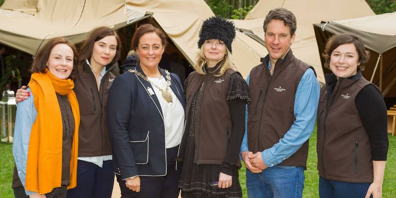 The team at Finnebrogue Woods pose for a photograph in front of the tipis