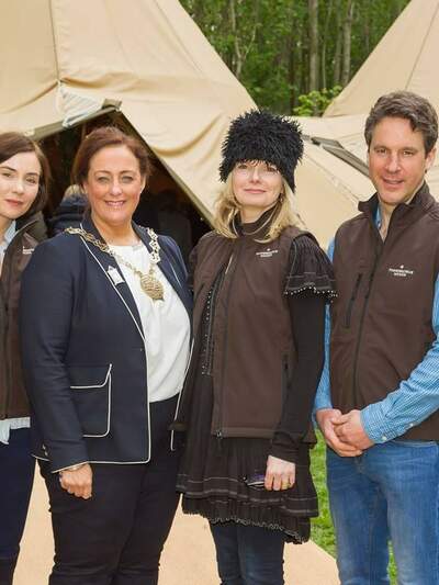 The team at Finnebrogue Woods pose for a photograph in front of the tipis