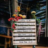 A DIY wooden pallet displays order of service for a Finnebrogue Woods Wedding