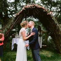 birde & groom kiss at the ceremony site at Finnebrogue Woods