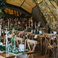 Finnebrogue Woods wedding Tipi are decorated with wildflowers, candles and fairy lights