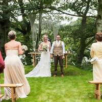 Guests stand & clap for the newly married couple at Finnebrogue Woods ceremony site