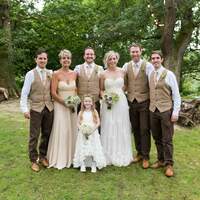 The wedding party pose for a photograph at Finnebrogue Woods firepit area