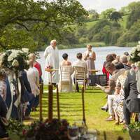 A wedding ceremony takes place overlooking Finnebrogue Woods and Lake