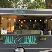 Wolf & Devour street kitchen stands among the trees at Finnebrogue Woods at Allen & Overy Corporate Summer party